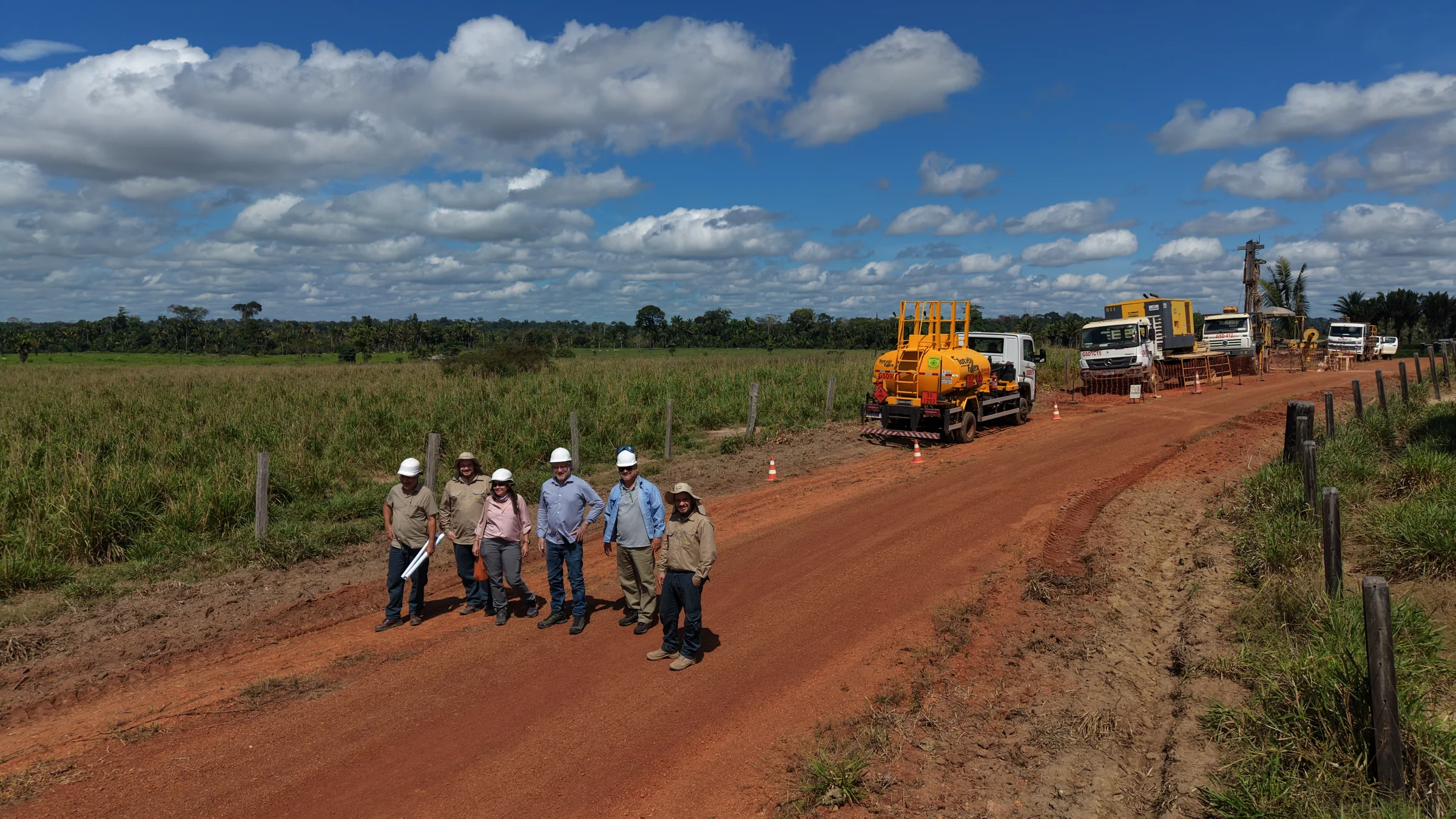 Field team on red dirt access road at the Madeira River Project